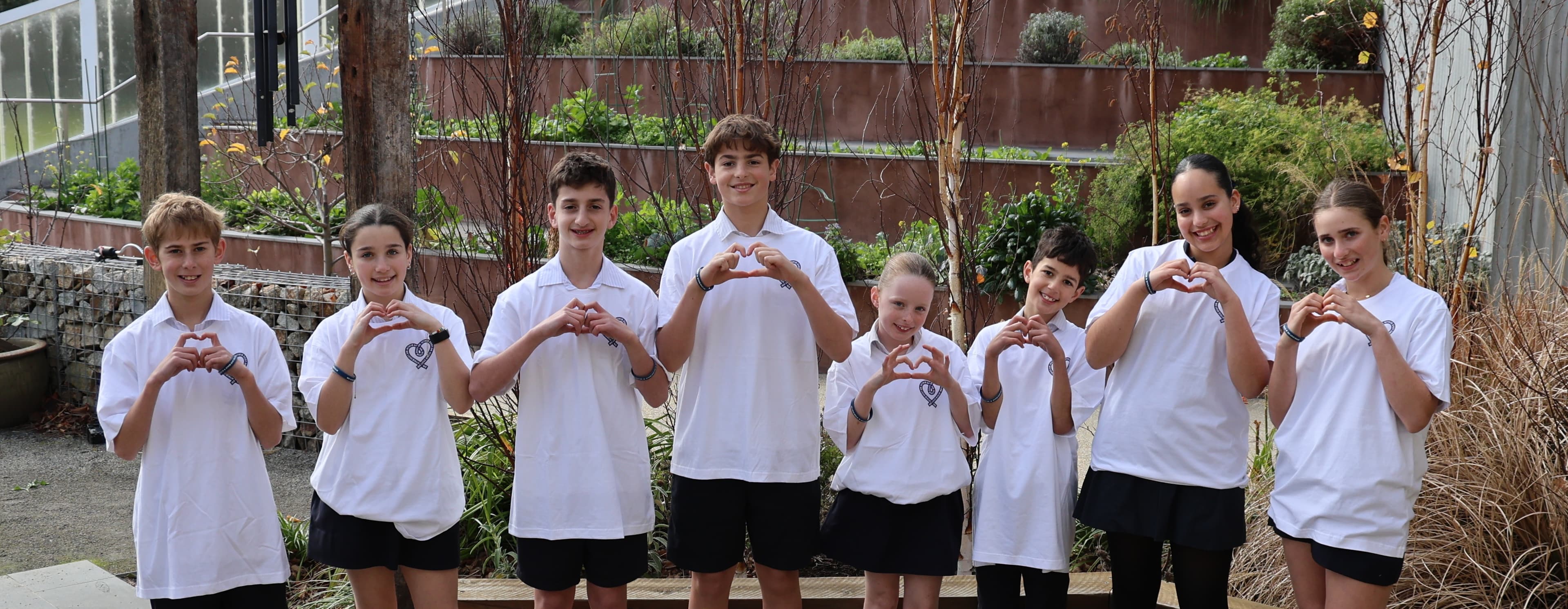 Bialik College students making heart shapes with their hands